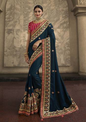 Grab This Very Beautiful And Heavy Designer Saree In Teal Blue Color Paired With Contrasting Rani Pink Colored Blouse. This Saree And Blouse Are Silk Based Beautified With Heavy , Attractive And Detailed Embroidery. Buy Now.