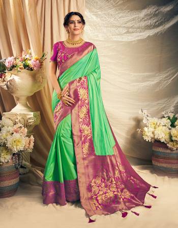 Look conventionally pretty and charming and grace the festivities with a dash of style in this color blocked silk saree. 