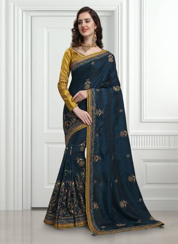 Enhance Your Personality Wearing This Attractive Looking Heavy Designer Saree In Dark Blue Color Paired With Contrasting Musturd Yellow Colored Blouse. This Saree And Blouse Are Fabricated On Soft Silk Which Is Light Weight, Durable And Easy To Carry All Day Long. 