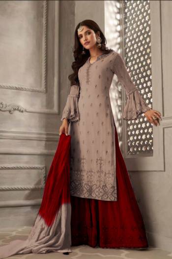 Grab This Very Beautiful Designer Sharara Suit In Mauve Colored Top Paired With Contrasting Red Colored Bottom And Shaded Red And Mauve Colored Dupatta. Its Embroidered Top Is Fabricated On Georgette Paired With Santoon Bottom And Chiffon Fabricated Dupatta. Its Pretty Color Pallete And Embroidery Will Earn You Lots Of Compliments From Onlookers. 