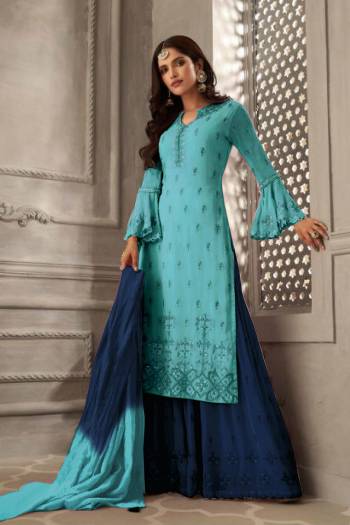 Grab This Very Beautiful Designer Sharara Suit In Sky BLue Colored Top Paired With Contrasting Blue Colored Bottom And Shaded Sky Blue & Blue Colored Dupatta. Its Embroidered Top Is Fabricated On Georgette Paired With Santoon Bottom And Chiffon Fabricated Dupatta. Its Pretty Color Pallete And Embroidery Will Earn You Lots Of Compliments From Onlookers. 