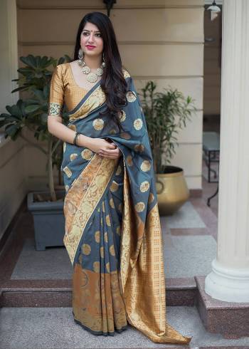 Celebrate This Festive Season With Beauty And Comfort In This Elegant Looking Designer Silk Based Saree In Dark Grey And Rust Color. This Saree And Blouse Are Fabricated On Banarasi Art Silk Beautified With Small Butti Weave All Over. Buy Now.