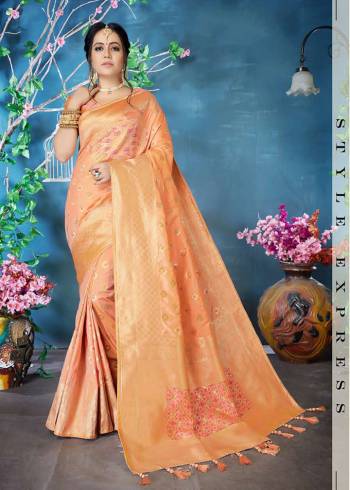 Here Is A Very Beautiful Designer Silk Based Saree In Peach Color Paired With Peach Colored Blouse. This Heavy Weaved Saree Is Fabricated On Banarasi Art Silk. It Is Rich Durable And Easy To Care For. 