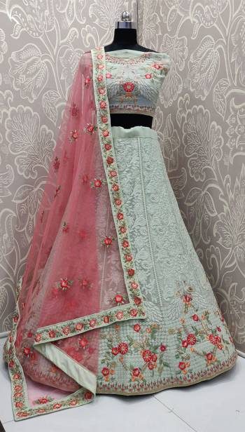 Here Is A Very Pretty Heavy Designer Lehenga Choli In Pastel Green Color Paired With Contrasting Pink Colored Dupatta. Its Blouse And Lehenga Are Fabricated On Georgette Beautified with Heavy Lakhnavi Embroidery Paired With Net Fabricated Dupatta. 