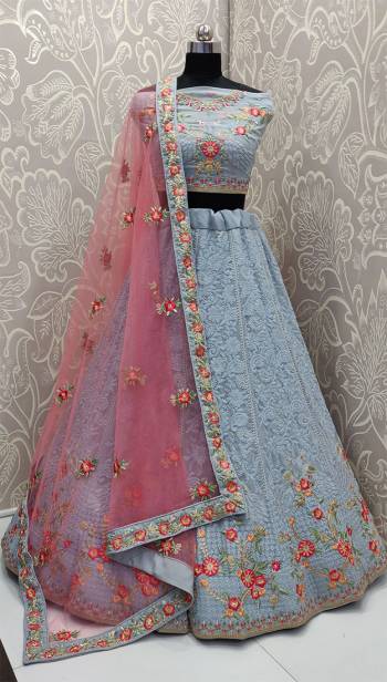 You Will Definitely Earn Lots Of Compliments Wearing This Heavy Designer Lakhnavi Lehenga Choli In Powder Blue Color Paired With Contrasting Pink Colored Dupatta. This Lehenga Choli Is Fabricated On Georgette Paired With Net Fabricated Dupatta. Buy Now. 