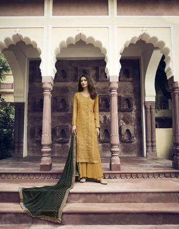 Celebrate This Festive Season Wearing This Lovely Designer Straight Suit In Musturd Yellow Color Paired With Contrasting Pine Green Colored Dupatta. Its Top IS Jacquard Silk Based Paired With Santoon Bottom And Georgette Dupatta. Its Pretty Color Pallete And Attractive Stone Work Will Earn You Lots Of Compliments From Onlookers. 