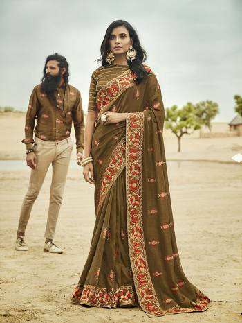 This Wedding Season, Be The Most Beautiful Of All Wearing This Heavy Designer Saree In Olive Green Color Beautified With Attractive Contrasting Colored Embroidery. This Saree And Blouse are Silk Based which also Gives A Rich Look To Your Personality. 