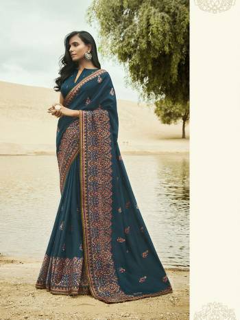 Here Is An Attractive Looking Heavy Embroidered Border Saree In Dark Blue Color Paired With Dark Blue Colored Blouse. This Saree And Blouse Are Silk Based Beautified With Contrasting Detailed Embroidery. 