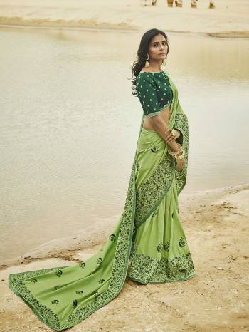 Go With The Shades of Green Wearing This Designer Saree In Light Green Color Paired With Green Colored Blouse. This Saree And Blouse Are Silk Based Beautified With Elegant Embroidery.