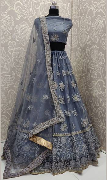 Get Ready For The Upcoming Wedding Season With This Very Beautiful And Heavy Designer Lehenga Choli In All Over Dark Grey Color. This Heavy Embroidered Lehenga Choli Is Fabricated On Net Beautified With Tone To Tone Embroidery. 