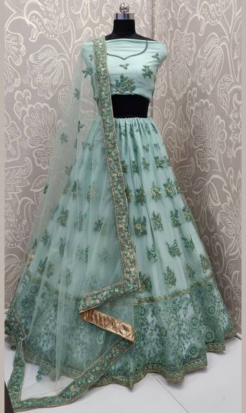 Get Ready For The Upcoming Wedding Season With This Very Beautiful And Heavy Designer Lehenga Choli In All Over Aqua Green Color. This Heavy Embroidered Lehenga Choli Is Fabricated On Net Beautified With Tone To Tone Embroidery. 