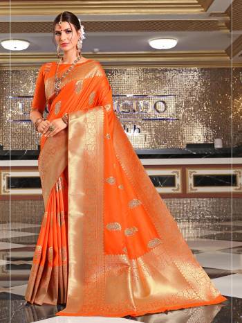 Bright And Visually Appealing Color Is Here With This Pretty Saree In Orange Color Paired With Orange Colored Blouse. This Saree And Blouse Are Silk Based Beutified With Weave All Over It. Buy This Saree Now.