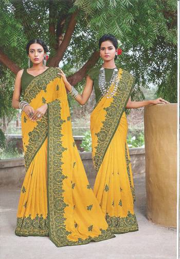Look Attractive In This Elegant Looking Designer Saree In Yellow Color Paired With Contrasting Olive Green Colored Blouse. This Saree And Blouse Silk Based Beautified With Pretty Thread Work. 