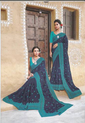 Go With The Shades Of Blue With This Designer Silk Based Saree In Navy Blue Color Paired With Blue Colored Blouse. This Saree Is Beautified With Heavy Embroidered Lace Border And Buttis All Over The Saree. 