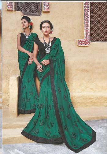 Go With Some Darker Shades With This Designer Silk Based Saree In Dark Green Color Paired With Black Colored Blouse. This Saree Is Beautified With Heavy Embroidered Lace Border And Buttis All Over The Saree. 