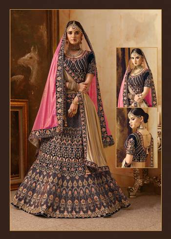 Get Ready For Your D-Day With This Heavy Designer Bridal Lehenga?Choli In Dark Blue Color Paired With Contrasting Pink Colored Dupatta. Its Heavy Embroidered Blouse And Lehenga Are Fabricated On Velvet Paired With Net Fabricated Dupatta.