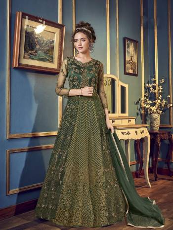 For The Upcoming Wedding And Festive Season,  Grab This Very Beautiful And Heavy Designer Indo-Western Dress In Pine Green Color. Its Top IS Fabricated On Net And Satin Paired With Santoon Bottom And chiffon Fabricated Dupatta. Also It Has A Satin Fabricated Lehenga , so That You Can Pair With Any Of The Bottoms As Per The Occasion. 