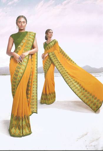 Celebrate This Festive Season Wearing This Designer Saree In Yellow Color Paired With Contrasting Green Colored Blouse. This Saree and Blouse Are Silk Based Beautified With Contrasting Thread Work. 