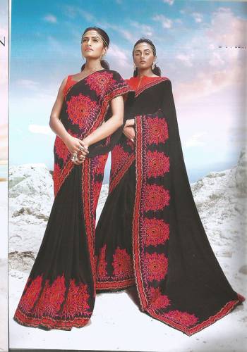 For A Bold And Beautiful Look, Here Is Black Colored Designer Silk Based Saree Paired With Red Colored Blouse. It Is Beautified With Bold Thread Embroidered Motifs. 