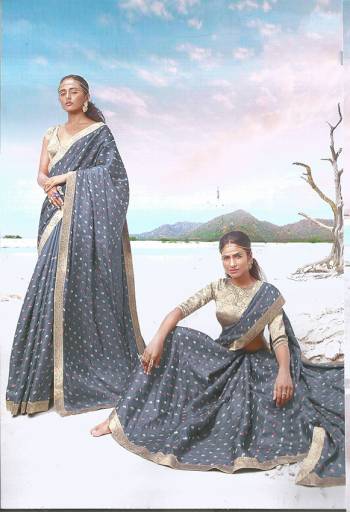 Rich And Elegant Looking Designer Silk Based IS Here To Flaunt Your Elegant Taste In Grey Color Paired With Golden Colored Blouse. It Is Beautified With Lace Border And Small Butti All Over The Saree. 