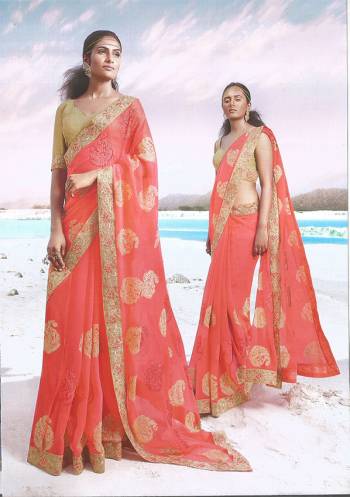 Celebrate This Festive Season Wearing This Designer Saree In Orange Color Paired With Contrasting Cream Colored Blouse. This Saree and Blouse Are Silk Based Beautified With Contrasting Thread Work. 