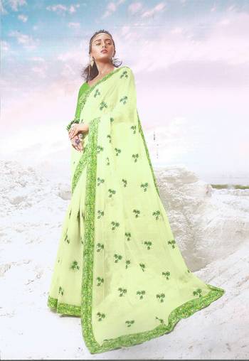 Here Is A Very Pretty Designer Saree In Light Green Color Paired With Green Colored Blouse. This Saree And Blouse are silk Based Beautified With Tone To Tone Embroidery. 