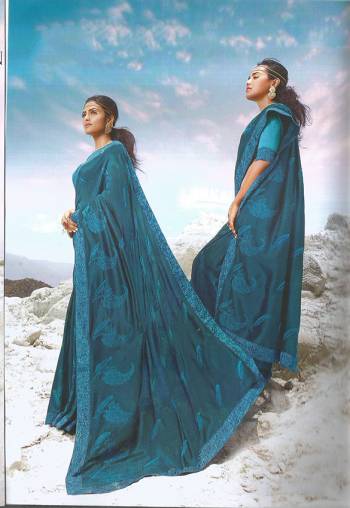 Rich And Elegant Looking Designer Silk Based IS Here To Flaunt Your Elegant Taste In Blue Color Paired With Blue Colored Blouse. It Is Beautified With Lace Border And Small Butti All Over The Saree. 