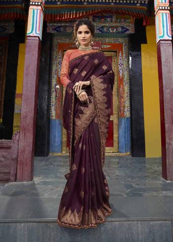 Shine Bright In This Beautiful Wine Colored Saree Paired With Contrasting Orange Colored Blouse. This Saree Is Fabricated On Weaving Art Silk Paired With Art Silk Fabricated Blouse. Its Rich Silk Fabric, Heavy Embroidery And Detailed Weave Will Earn You Lots Of Compliments From Onlookers. 