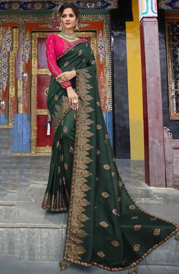 Add This Lovely Shade To Your Wardrobe With This Heavy Designer Saree In Pine Green Color Paired With Contrasting Rani Pink Colored Blouse. This Saree And Blouse Are Silk Based Beautified With Weave And Heavy Embroidery. Buy Now.