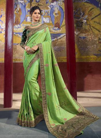 Lovely Shades In Green Are Here With This Pretty Saree Paired With Dark Green Colored Blouse. This Saree And Blouse Are Fabricated On Art Silk Beautified With Weave And Embroidery Which Will Definitely Earn You Lots Of Compliments From Onlookers.