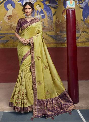 New And Unique Color Pallete Is Here With This Heavy Designer Weaving Silk Saree In Pear Green Color Paired With Contrasting Purple Colored Blouse. It Has Elegant Detailed Weave With Heavy Embroidery Work. 