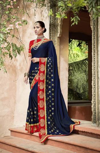 Enhance your Personality In Bold Color Pallete Wearing This Beautiful Designer Saree In Navy Blue Color Paired With Contrasting Red Colored Blouse. This Saree And Blouse Are Silk Based Which Gives A Rich Look To Your Personality. 