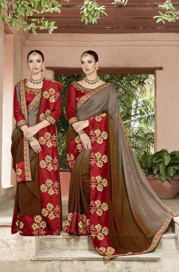 Shades Can Never Go Out Of Style, So Grab One Of Them By Getting This Beautiful Shaded Saree In Grey And Brown Color Paired With Contrasting Red Colored Blouse. This Saree And Blouse Are Silk Based Beautified With Deatiled Work .