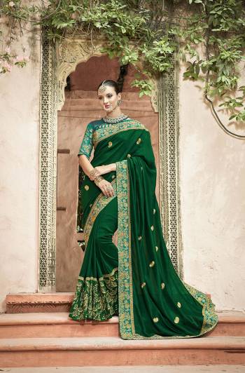 Here Is A Very Beautiful Designer Saree In Green Color Paired With Teal Blue Colored Blouse. This Saree And Blouse Are Silk Based Beautified With Attractive Embroidery All Over. 