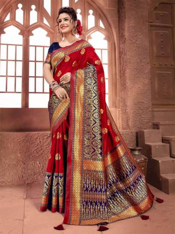 Adorn The Angelic Look Wearing This Saree In Red Color Paired With Contrasting Navy Blue Colored Blouse. This Saree And Blouse Are Silk Based Beautified With Weave All Over. 