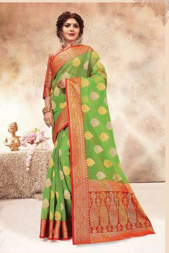 Here Is A Very Pretty Saree Suitable For The Upcoming Festive and Wedding Season In Green Color Paired With Contrasting Orange Colored Blouse. This Saree Is Fabricated On Chanderi Silk Paired With Jacquard Silk Fabricated Blouse. 