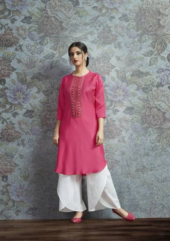 Celebrate This Festive Season With A New Indo-Western Look Wearing This Pair Of Kurti In Rani Pink Color Paired With White Colored Bottom. Its Top Is Fabricated On Modal Satin Beautified With Embroidered Lace Border Paired With Crepe Fabricated Unstitched Bottom. Buy This Lovely Pair Now.