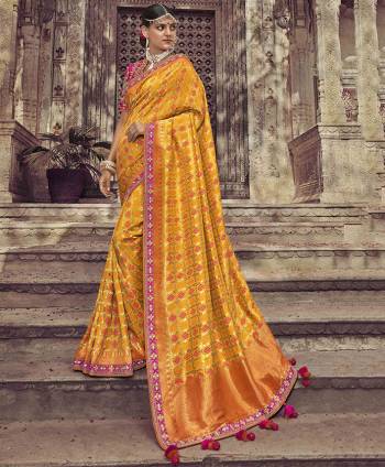 Celebrate This Festive Season Wearing This Designer Saree In Musturd Yellow Color Paired With Contrasting Rani Pink Colored Blouse. This Saree And Blouse Are Silk Based Beautified With Weave And Embroidery. Buy Now.