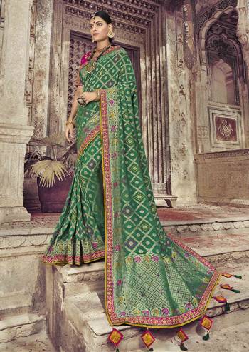 Go With The Shades Of Green Wearing This Saree In Green Color Paired With Dark Pink Color Blouse. This Saree And Blouse Are Fabricated On Dola Art Silk Beautified With Weaving And Attractive Embroidery. Buy This Pretty Saree Now.