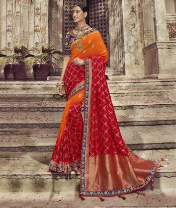 Shades Can Never Go Out Of Style, So Grab This Very Beautiful And Attractive Looking Shaded Saree In Orange And Red Color Paired With Contrasting  Navy Blue Colored Blouse. This Saree And Blouse Are Dola Art Silk Fabricated Which Also Gives a rich Look To Your Personality. 