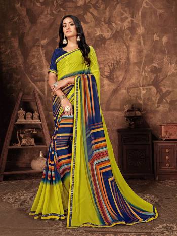 Celebrate This Festive Season with Beauty And Comfort Wearing This Light Weight Georgette Based Saree In Yellow And Blue Color Paired With Navy blue Colored Art silk fabricated Blouse. 