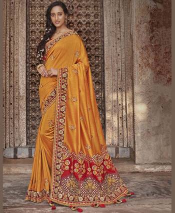 Celebrate This Festive And Wedding Season With This Very Beautiful And Heavy Designer Saree In Musturd Yellow Color Paired With Contrasting Red Colored Blouse. This Saree And Blouse Are Silk Based Which Also Gives A Rich Look To Your Personality. 