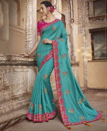 Add This Very Beautiful And Heavy Designer Saree To Your Wardrobe In Blue Color Paired With Contrasting Rani Pink Colored Blouse. This Saree And Blouse are Silk Based Beautified With Embroidery Over the Saree And Blouse. Buy Now.