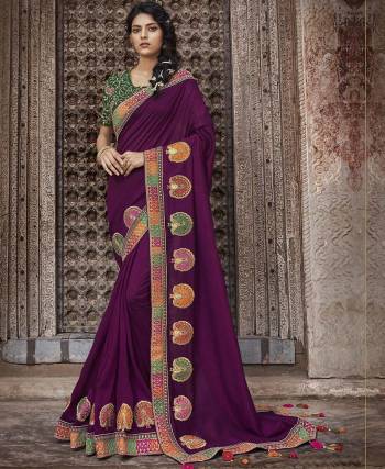 For A Bold And Beautiful Look, Grab This Rich Silk Based Saree In Wine Color Paired With Contrasting Dark Green Colored Blouse. Its Detailed Emboidery And Bold Colors Will Give A Look Like Never Before. 