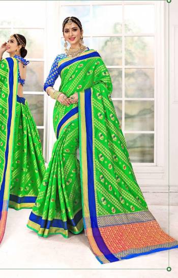 Celebrate This Festive Season In A Proper Traditional Look With This Silk Based Weaved Saree In Parrot Green Color Paired With Contrasting Royal Blue Colored Blouse. Buy This Lovely Piece Now.