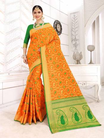 For A Royal Look, Grab This Heavy Weaved Designer Saree In Orange color Paired With Contrasting Green Colored Blouse. This Saree And Blouse are Silk Based Beautified With Weave All Over. Buy Now.