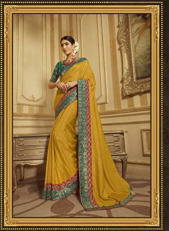 Celebrate This Festive Season With Beauty And Comfort Wearing This Designer Saree In Musturd Yellow Color Paired With Contrasting Teal Green Colored Blouse. This Saree And Blouse Are Fabricated On Art Silk And Jacquard Silk Beautified With Embroidery. 