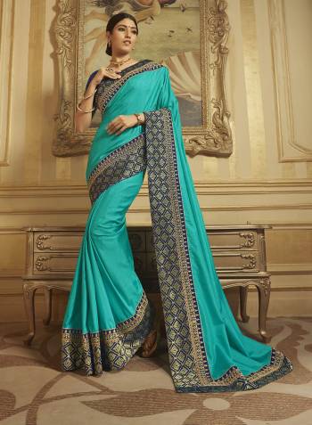 Go With The Shades Of Blue Wearing This Lovely Designer Saree In Turquoise Blue Color Paired With Navy Blue Colored Blouse. This Saree Is Fabricated On Art Silk And Jacquard Silk Paired With Art Silk Fabricated Embroidered Blouse. 