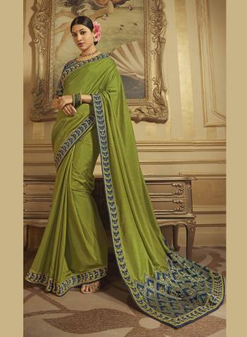 You Will Definitely Earn Lot Of Compliments Wearing This Elegant Looking Designer Saree In Olive Green Color Paired With Navy Blue Colored Blouse. This Saree Is Fabricated On Art Silk And Jacquard Silk Beautified With Detailed Embroidery And Weave. Buy This Lovely Saree Now.