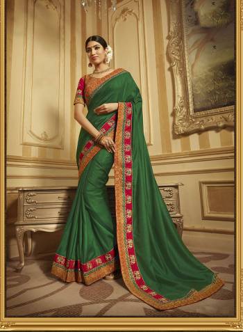 Celebrate This Festive Season With Beauty And Comfort Wearing This Designer Saree In Green Color Paired With Contrasting Red Colored Blouse. This Saree And Blouse Are Fabricated On Art Silk And Jacquard Silk Beautified With Embroidery. 